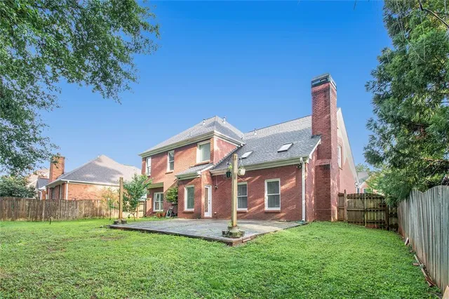 a view of a house with a yard and sitting area