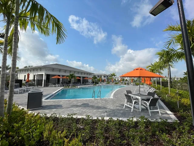 an outdoor space with patio and white umbrellas