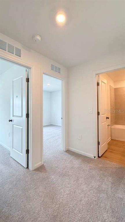 5174 Clay Whaley Road St. Cloud, FL 34772 - Photo 14 of 25 an empty room with a bathroom and mirror