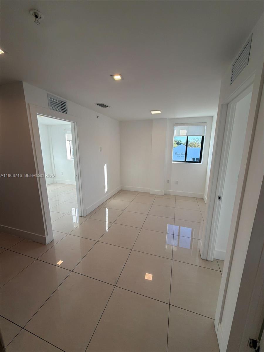 829 Southwest 18th Avenue, Unit 311 Miami, FL 33135 - Photo 5 of 11 a view of an empty room and a bathroom