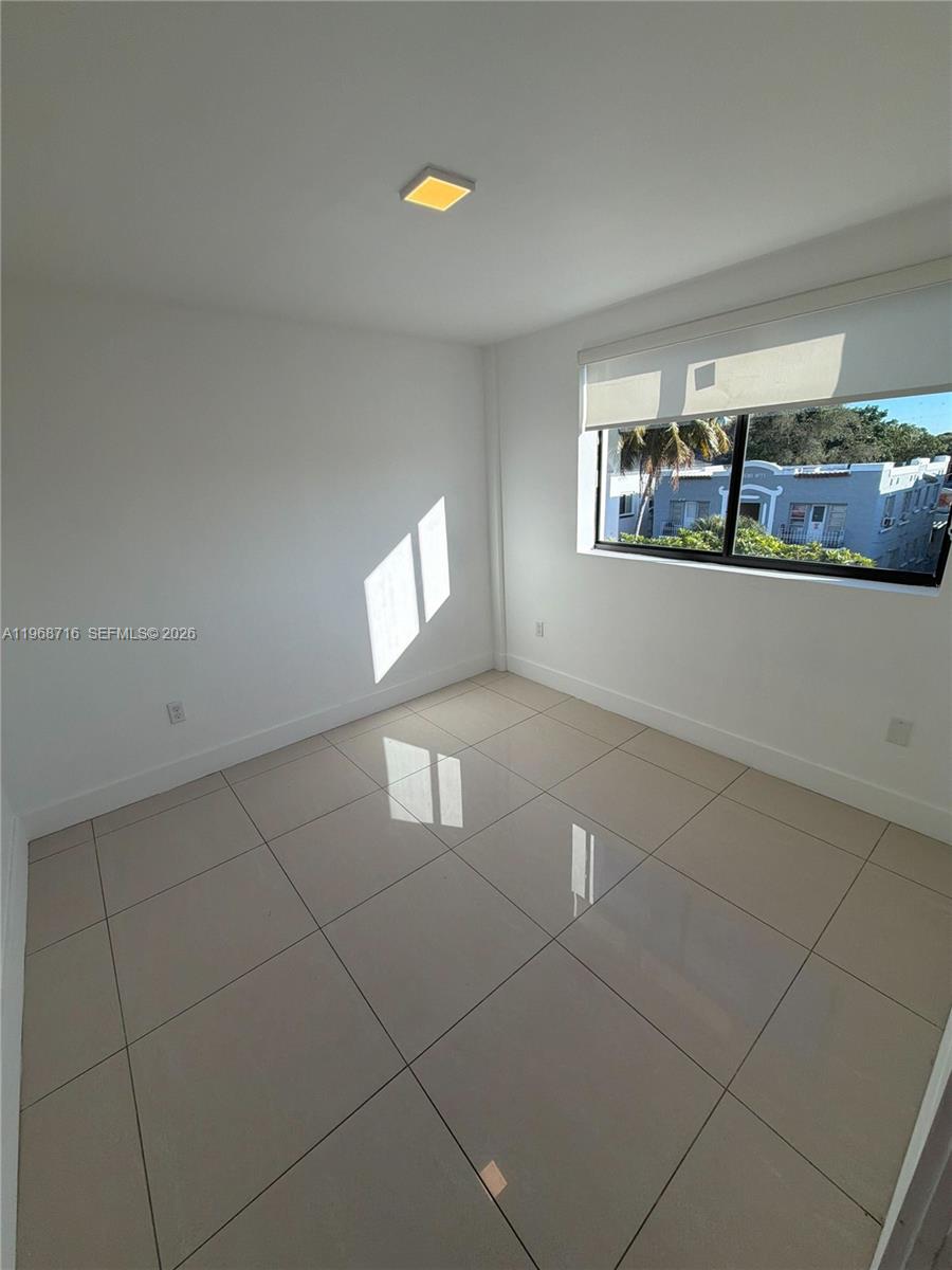 829 Southwest 18th Avenue, Unit 311 Miami, FL 33135 - Photo 8 of 11 a view of an empty room with a window