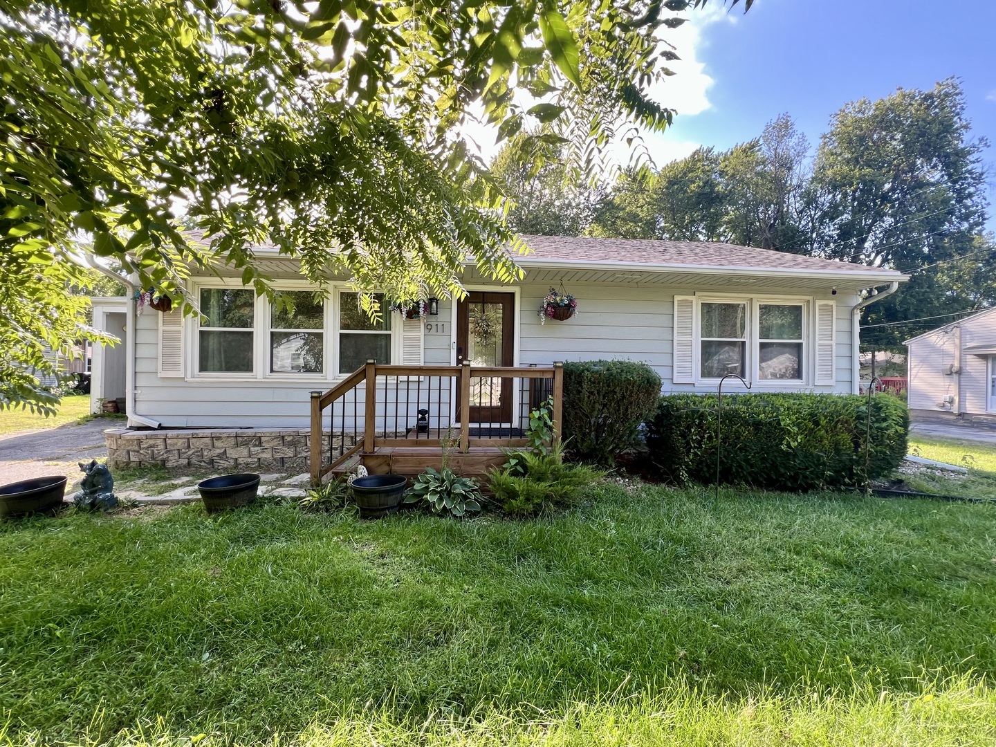 a front view of a house with a yard and trees