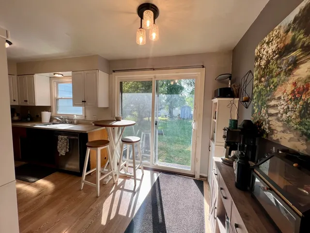 a kitchen with a table chairs stove and cabinets