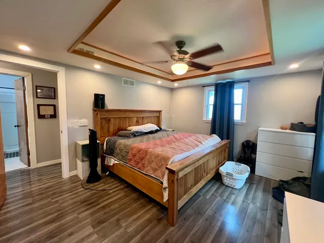 a bedroom with a bed and a mirror