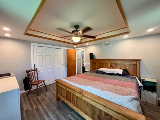 a bed room with a bed and a chair