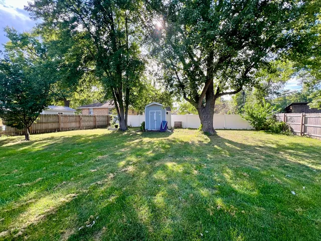 a view of a backyard with large trees