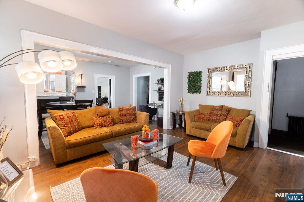 40-42 Harding Terrace Newark, NJ 07112 - Photo 2 of 15 a living room with furniture and a large mirror with wooden floor