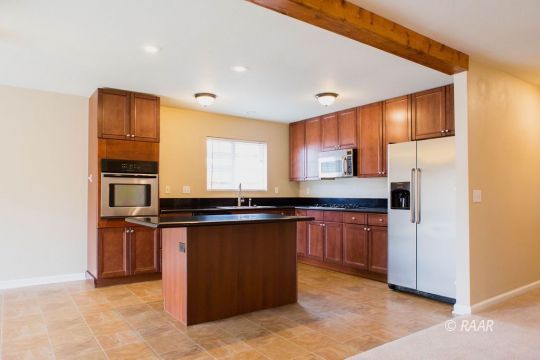 1633 South Farragut Street Ridgecrest, CA 93555 - Photo 5 of 30 a kitchen with stainless steel appliances granite countertop a stove a sink and a refrigerator