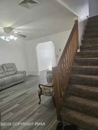a living room with furniture and a mirror