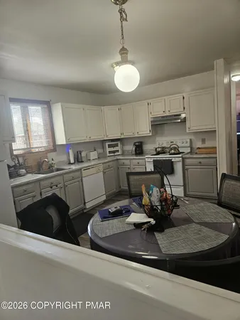 a kitchen with a white cabinets and white appliances