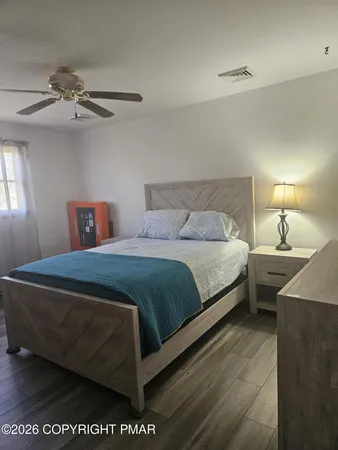 a bedroom with a bed and a window