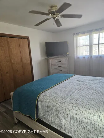 a view of a room with wooden floor