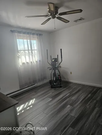 a view of a room with wooden floor and windows