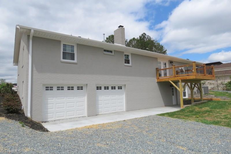 8529 Lasater Road Clemmons, NC 27012 - Photo 27 of 30 Exterior Back. Plenty of parking space. Two Car basement garage with plenty of space for a workbench, shelving, storage...Large finished basement with half bath & closets.