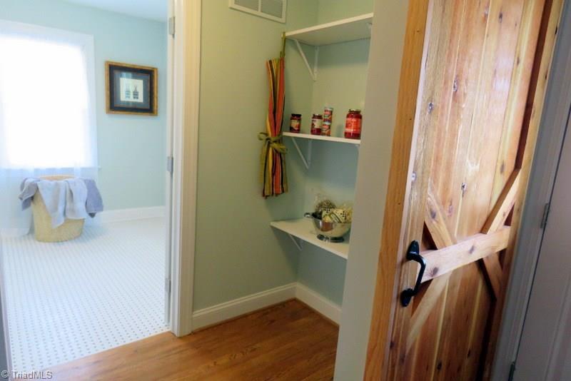 8529 Lasater Road Clemmons, NC 27012 - Photo 10 of 30 Barn Door #2 is in the Kitchen and leads to a walk-in Pantry with shelves and a larger walk-in laundry.