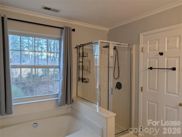 a bathroom with a shower and a tub
