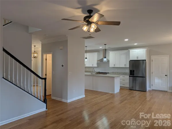 a kitchen with stainless steel appliances granite countertop a refrigerator a sink and a stove