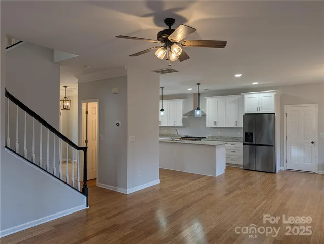 a bathroom with a light fixture and a chandelier fan