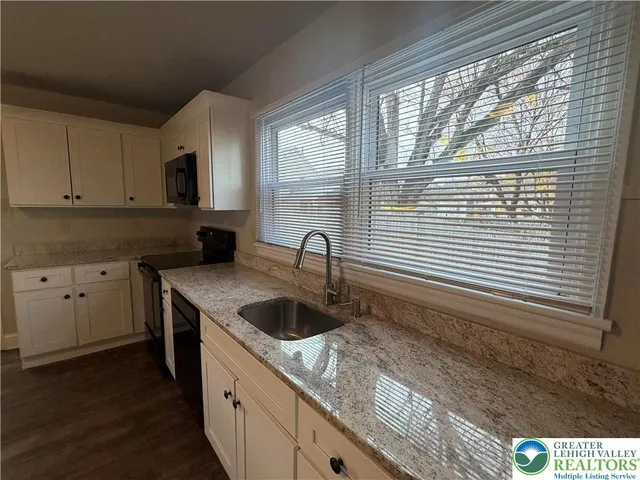 a kitchen with a sink and a window