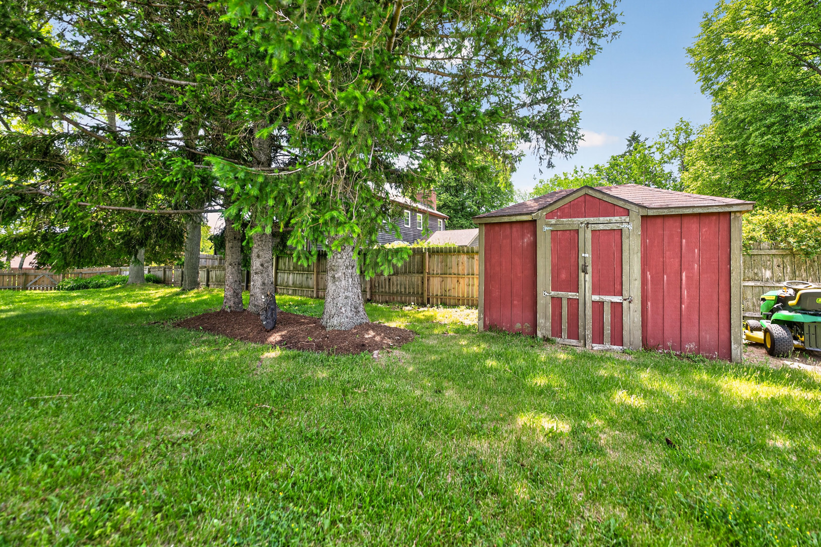 9 Jennifer Lane DeKalb, IL 60115 - Photo 15 of 16 a view of a wooden house with a big yard and large trees