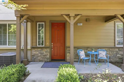 a front view of a house with outdoor seating