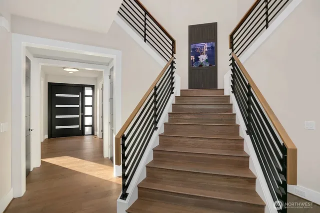 a view of entryway and hall with wooden floor