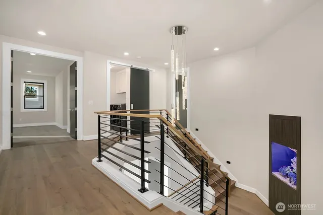 a view of a hallway with stairs and furniture