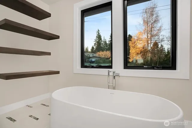 a white bath tub sitting next to a window