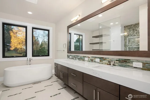 a bathroom with a large tub sink and mirror