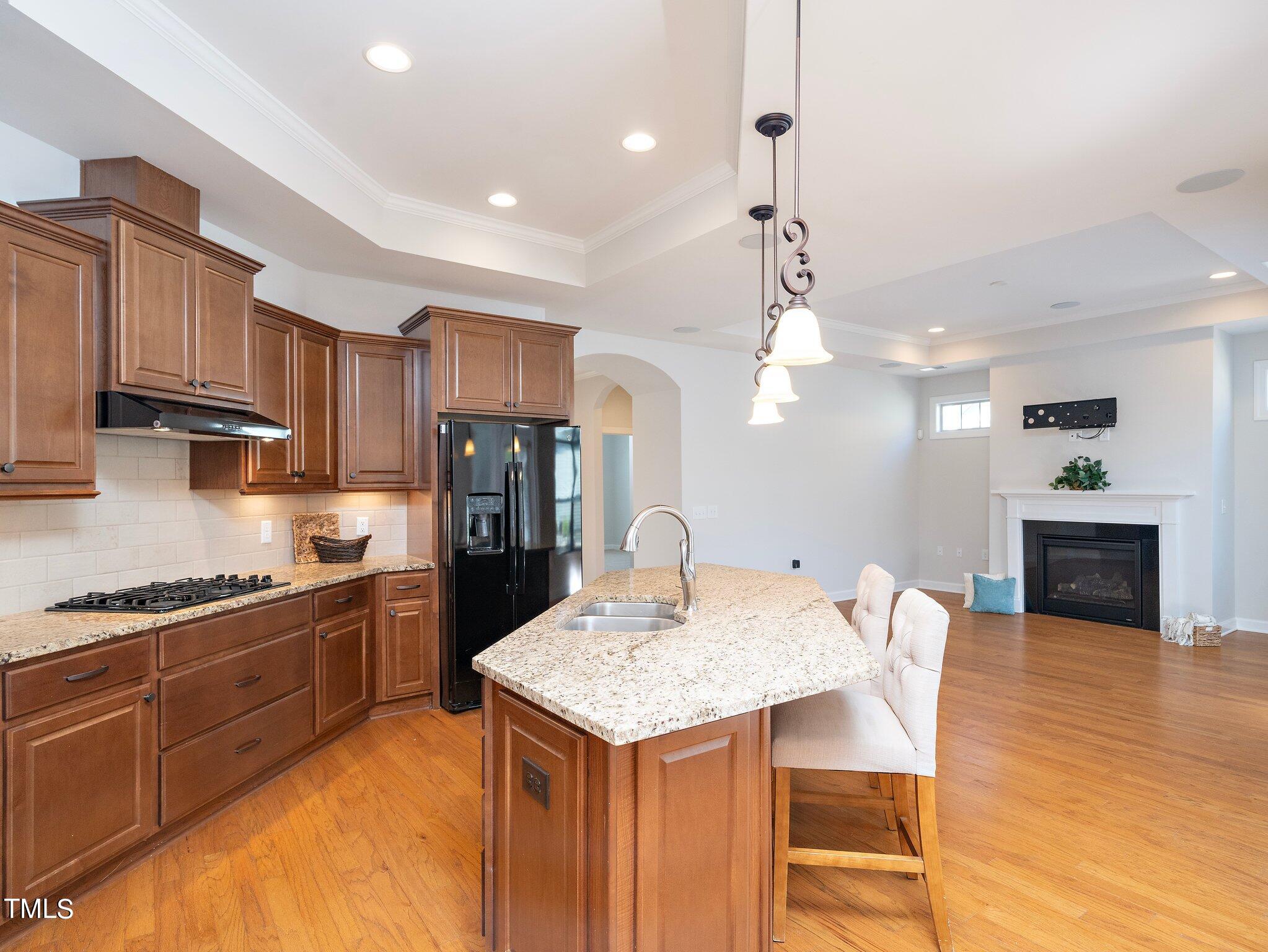 1356 Prevenient Drive Wake Forest, NC 27587 - Photo 12 of 27 a kitchen with granite countertop kitchen island stainless steel appliances a sink a stove a refrigerator cabinets and chairs