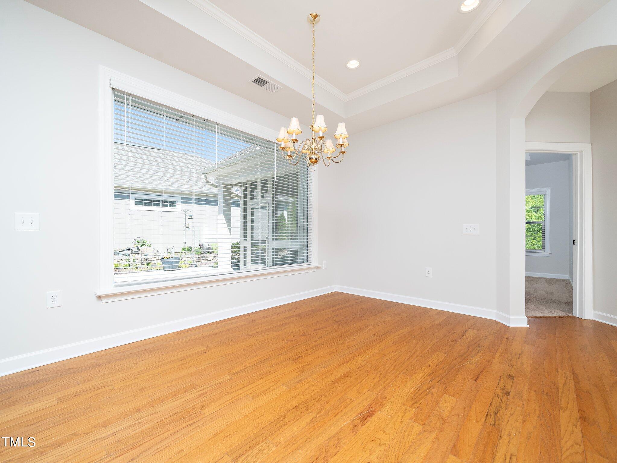 1356 Prevenient Drive Wake Forest, NC 27587 - Photo 13 of 27 a view of empty room with wooden floor and fan