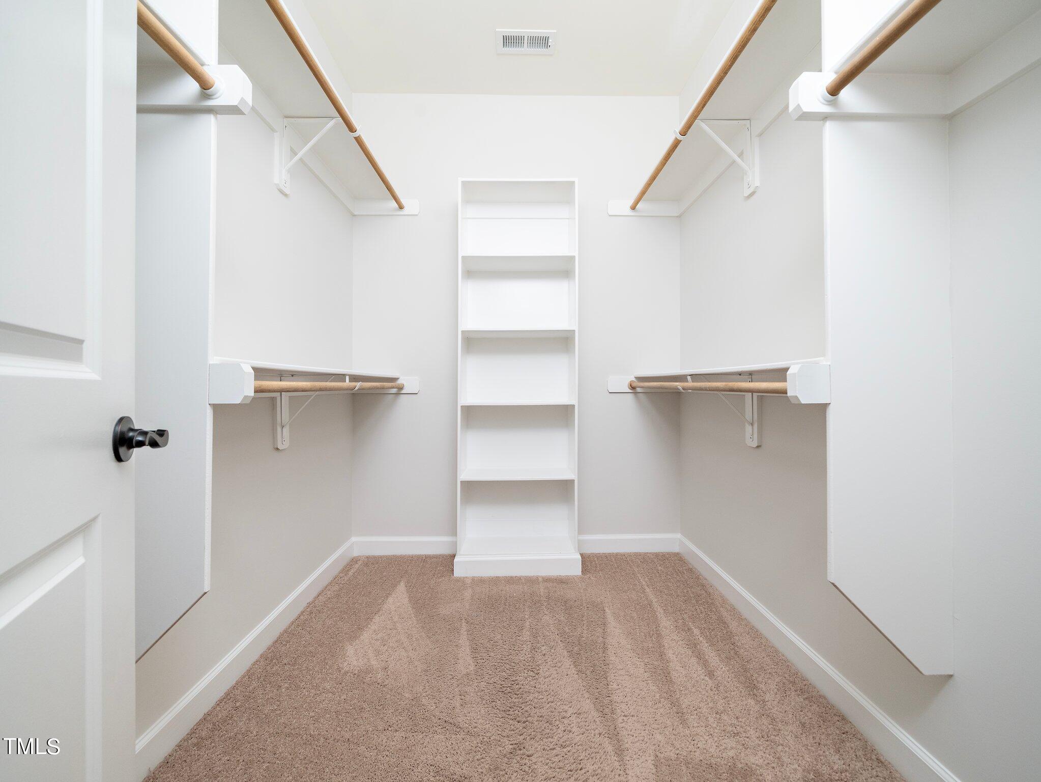 1356 Prevenient Drive Wake Forest, NC 27587 - Photo 18 of 27 a view of walk in closet with empty racks