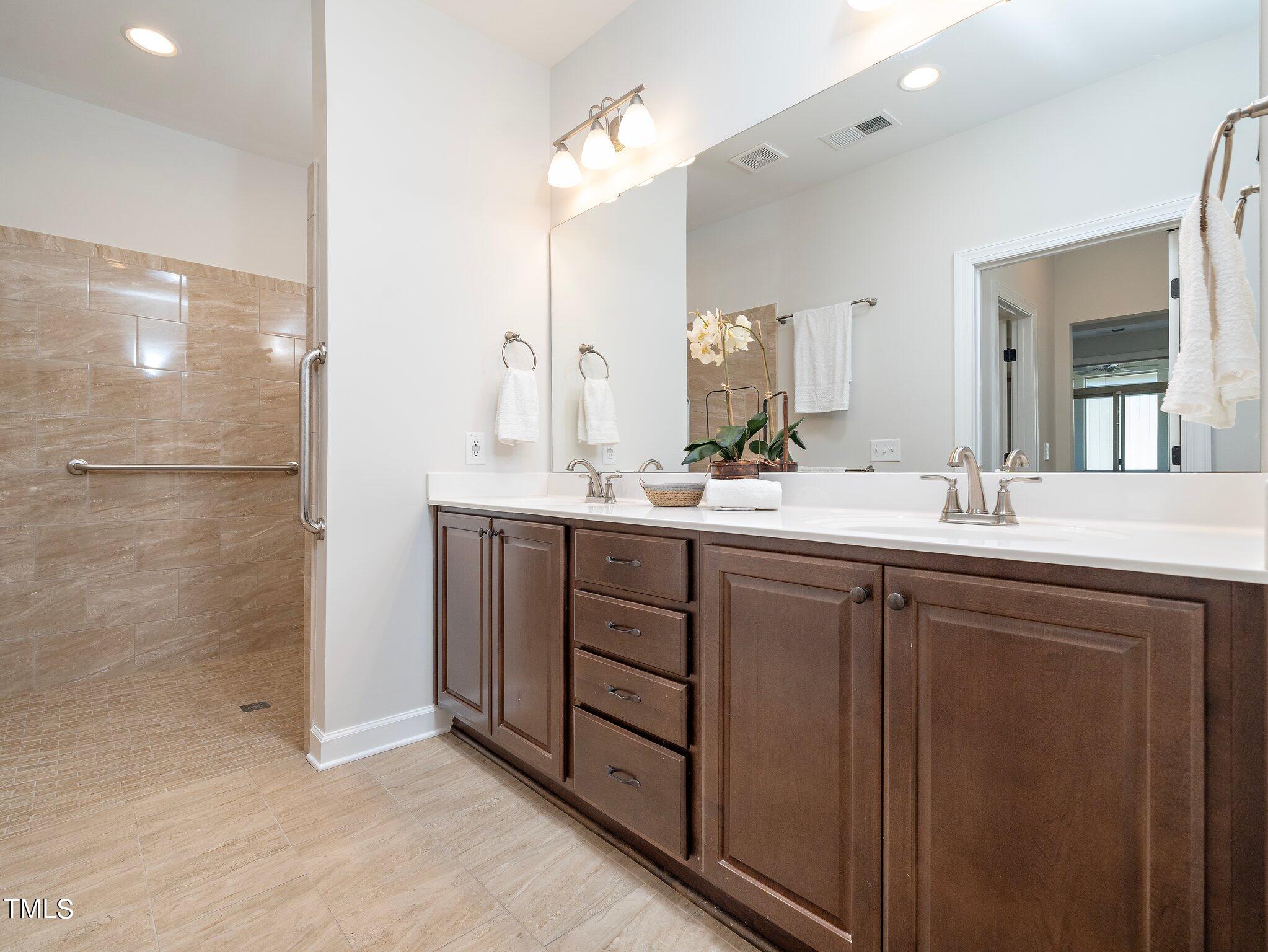 1356 Prevenient Drive Wake Forest, NC 27587 - Photo 19 of 27 a bathroom with a double vanity sink mirror and double