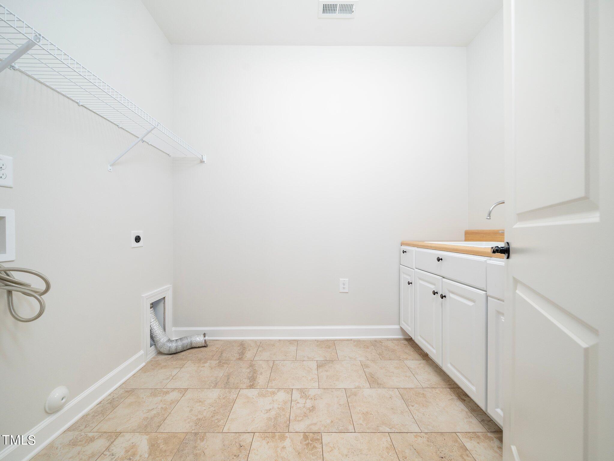 1356 Prevenient Drive Wake Forest, NC 27587 - Photo 22 of 27 a view of a kitchen with white cabinets