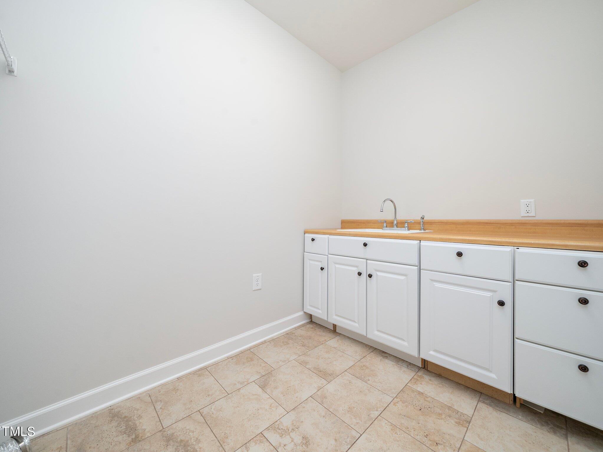 1356 Prevenient Drive Wake Forest, NC 27587 - Photo 23 of 27 a utility room with cabinets