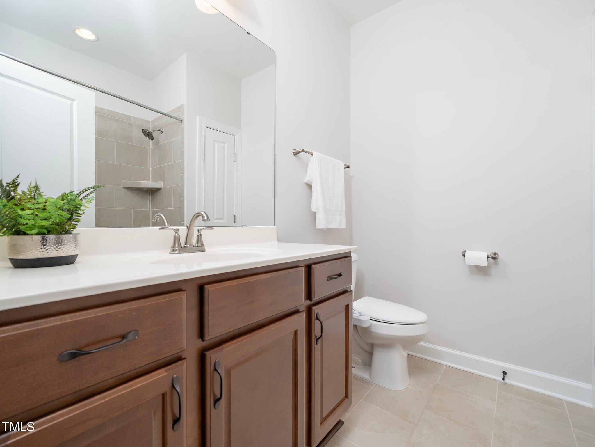 1356 Prevenient Drive Wake Forest, NC 27587 - Photo 6 of 27 a bathroom with a sink toilet and a mirror