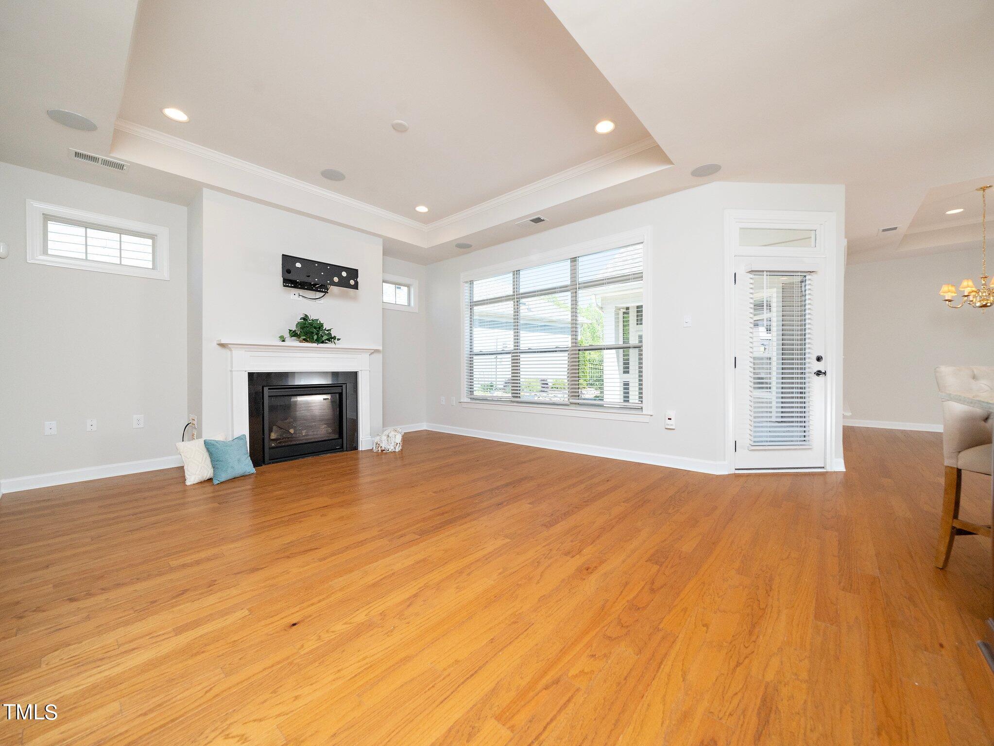 1356 Prevenient Drive Wake Forest, NC 27587 - Photo 7 of 27 an empty room with windows and fireplace
