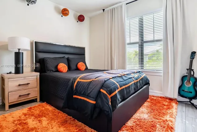 a bedroom with a bed and a window