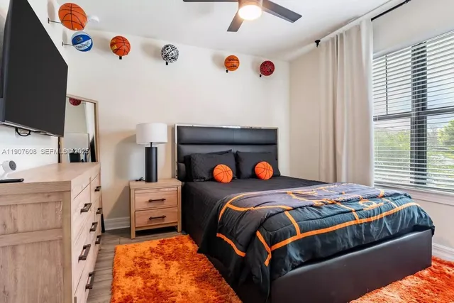 a bedroom with a bed and a flat tv screen