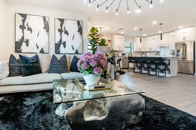 a living room with furniture and a chandelier