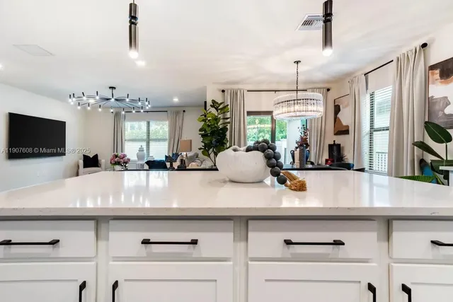 a view of living room with a flat screen tv and a chandelier