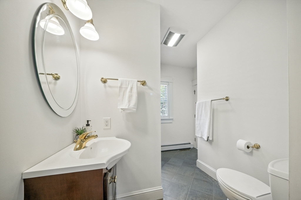 11 Dana Road Newton, MA 02465 - Photo 16 of 35 a bathroom with a sink a toilet and a mirror