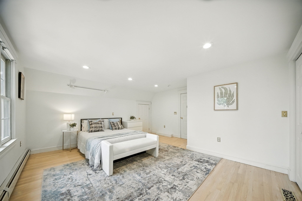 11 Dana Road Newton, MA 02465 - Photo 19 of 35 a spacious bedroom with a bed and a couch