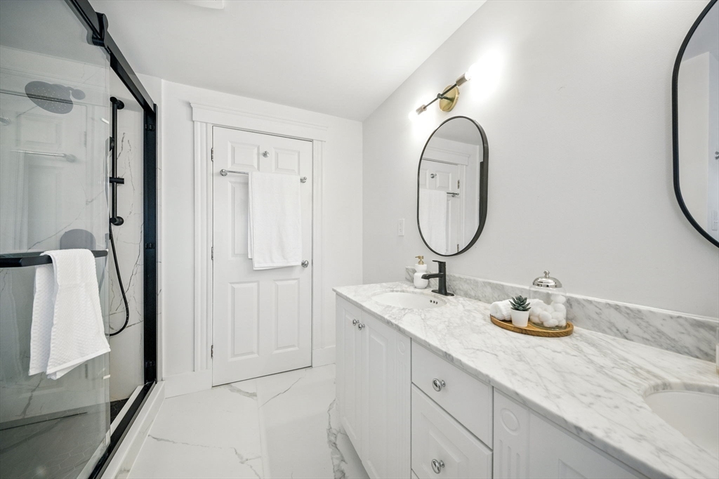 11 Dana Road Newton, MA 02465 - Photo 22 of 35 a bathroom with a granite countertop sink and a mirror