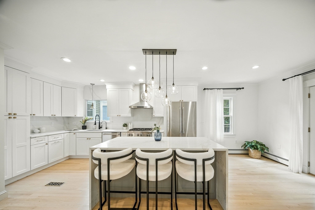 11 Dana Road Newton, MA 02465 - Photo 6 of 35 a kitchen with a dining table chairs and white cabinets