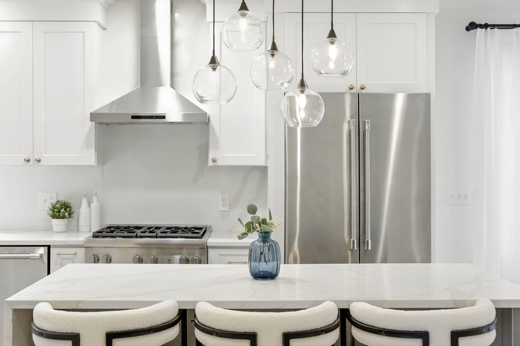 11 Dana Road Newton, MA 02465 - Photo 9 of 35 a kitchen with stainless steel appliances a white table and chairs