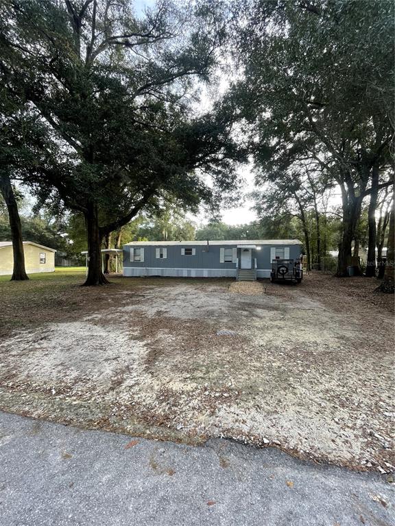 6904 Southwest 85th Place Ocala, FL 34476 - Photo 1 of 1 a view of a yard with a tree