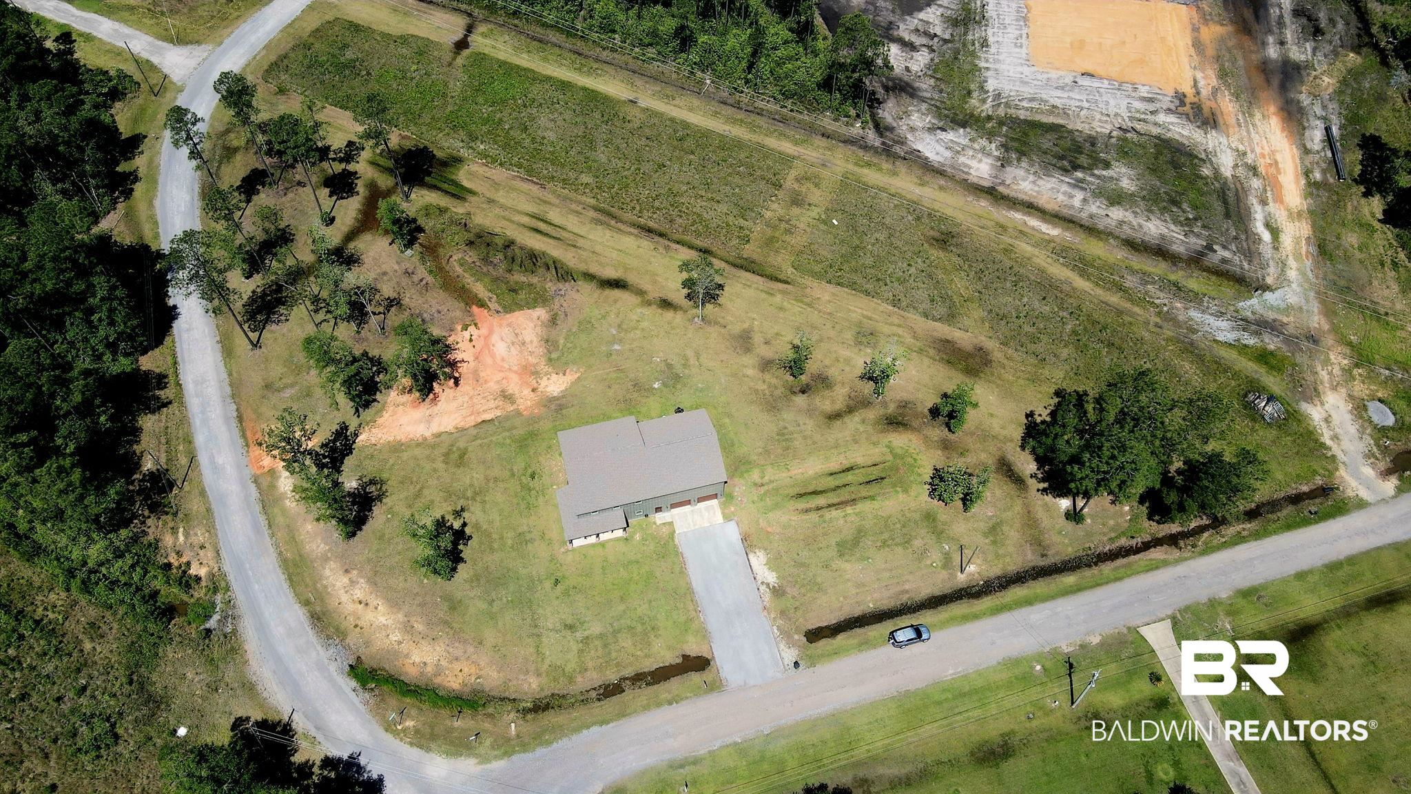 11025 Creax Road Axis, AL 36505 - Photo 41 of 45 Expansive property featuring a single-story residence, asphalt driveway, and mature landscaping