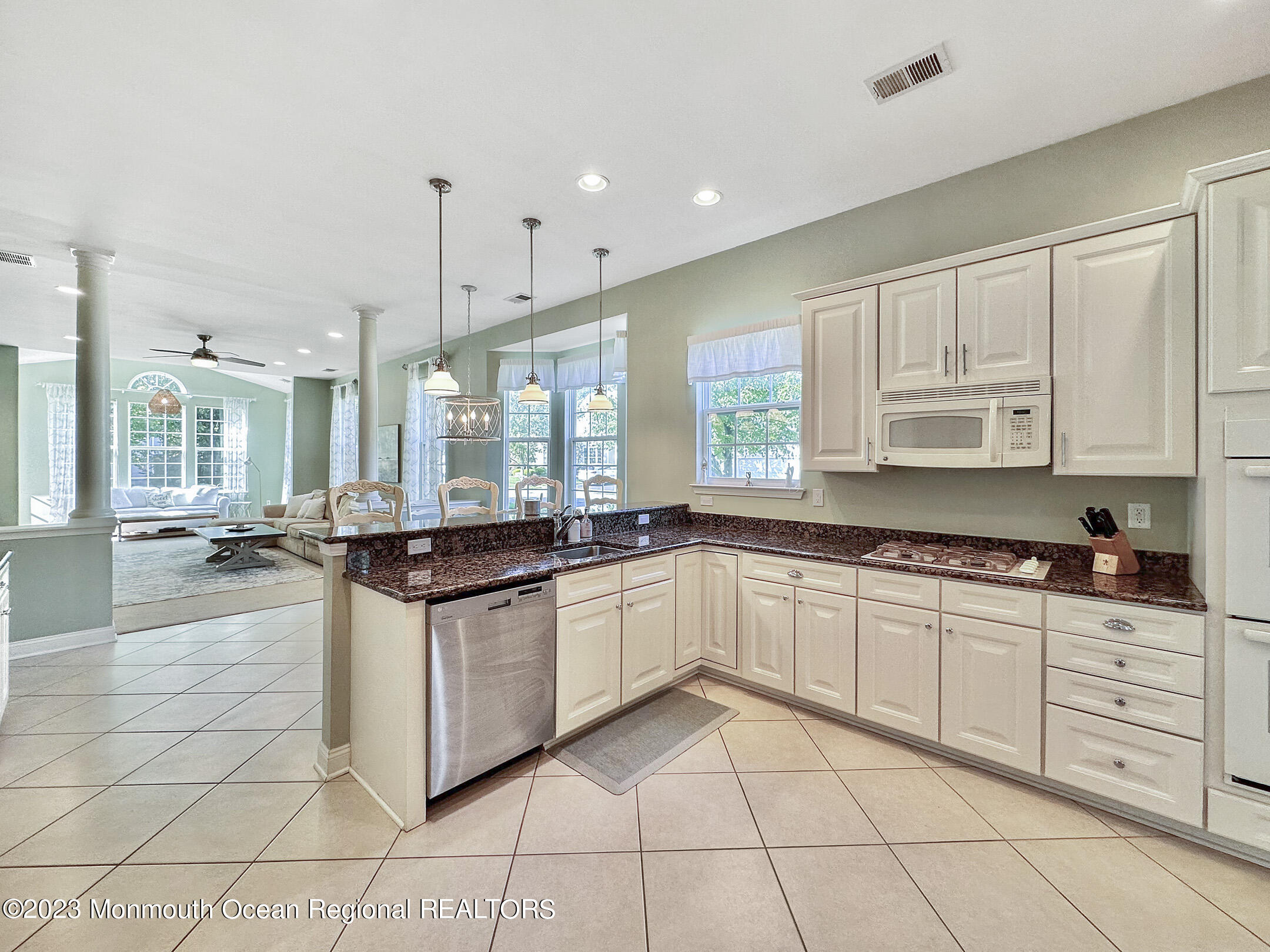 2 Arcaro Road Manalapan, NJ 07726 - Photo 14 of 42 a kitchen with stainless steel appliances granite countertop a stove and white cabinets