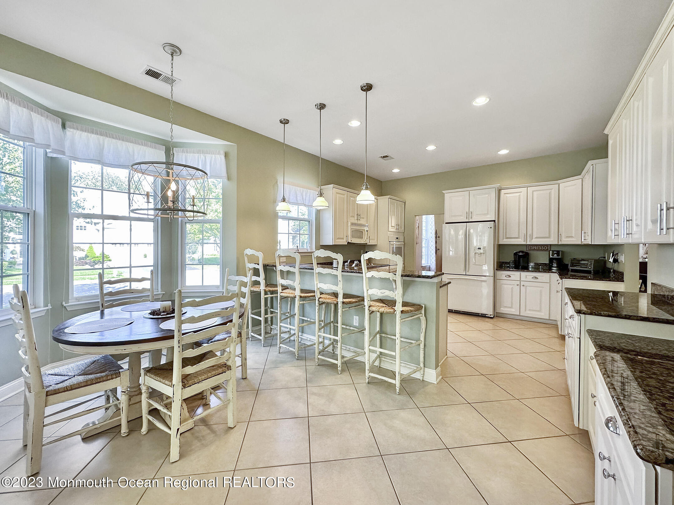 2 Arcaro Road Manalapan, NJ 07726 - Photo 17 of 42 a kitchen with stainless steel appliances kitchen island granite countertop a stove a table and chairs in it